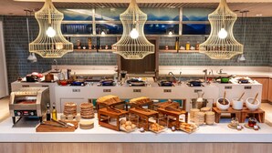 A modern kitchen with a central island, wooden utensils, and a variety of food items. - Hilton Garden Inn Phuket, Thailand (Choeng Thale)