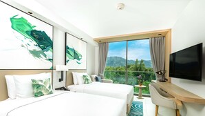 A hotel room with two beds, a desk, a TV, and a large window with a mountain view. - Hilton Garden Inn Phuket, Thailand (Choeng Thale)