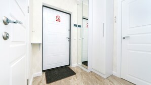 A hotel entrance with a white door, a glass door, and a black doormat. - Comfortable apartment in a new house (Kyiv)