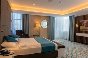 In-room safe, desk, laptop workspace, blackout drapes - Royal Crown Hotel (Muscat)