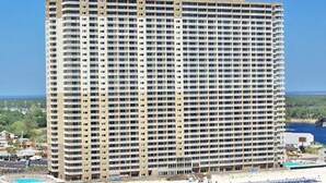 A high-rise hotel with multiple floors, a beachside location, and a pool area. - Beautiful gulf front, amazing views. Walk to Pier Park.   (Panama City Beach)