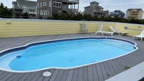 A swimming pool with a tiled edge, surrounded by a wooden deck. - Spectacular OCEAN and SOUND VIEW ,Elevator, Private Pool, Hot Tub, Lux Retreat (Salvo)