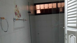 A bathroom with a glass shower enclosure, a marble sink, and a white door. - Hotel Casa Garces Cartagena (Cartagena)