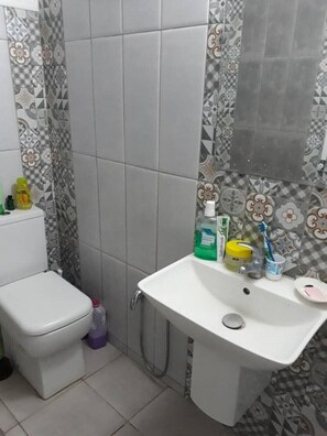 A bathroom with a toilet, sink, and shower. - Villa LARIBI seaside in Nabeul. (nabeul)