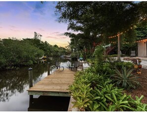 Relax by the serene river, surrounded by lush greenery and a tranquil atmosphere.