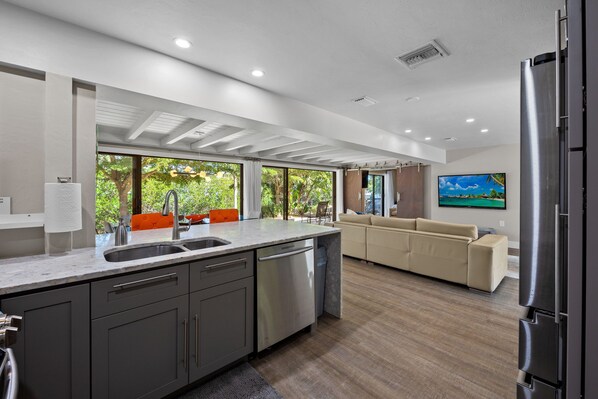 Enjoy cooking in this well-equipped kitchen with a refrigerator, sink, and dishwasher.