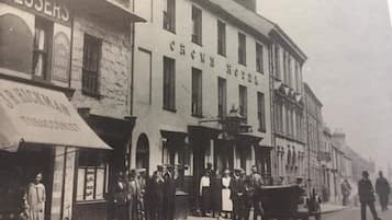 A historical building with the sign 'Crown Hotel' prominently displayed.