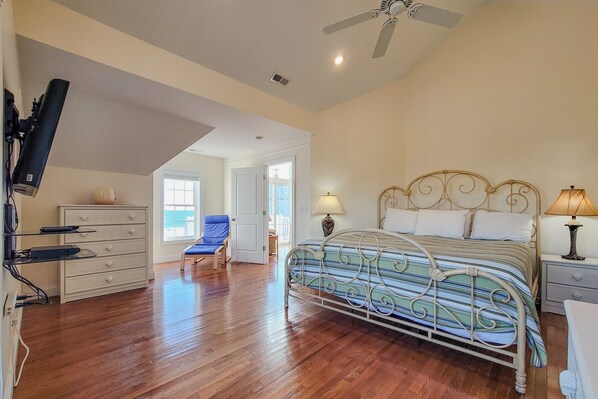 A bedroom with a bed, a chair, a dresser, and a ceiling fan. - Shore Beats Work – Clock Out & Chill! (North Topsail Beach)