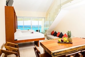 Enjoy ocean views from the balcony and relax in the spacious bed with a comfortable headboard.