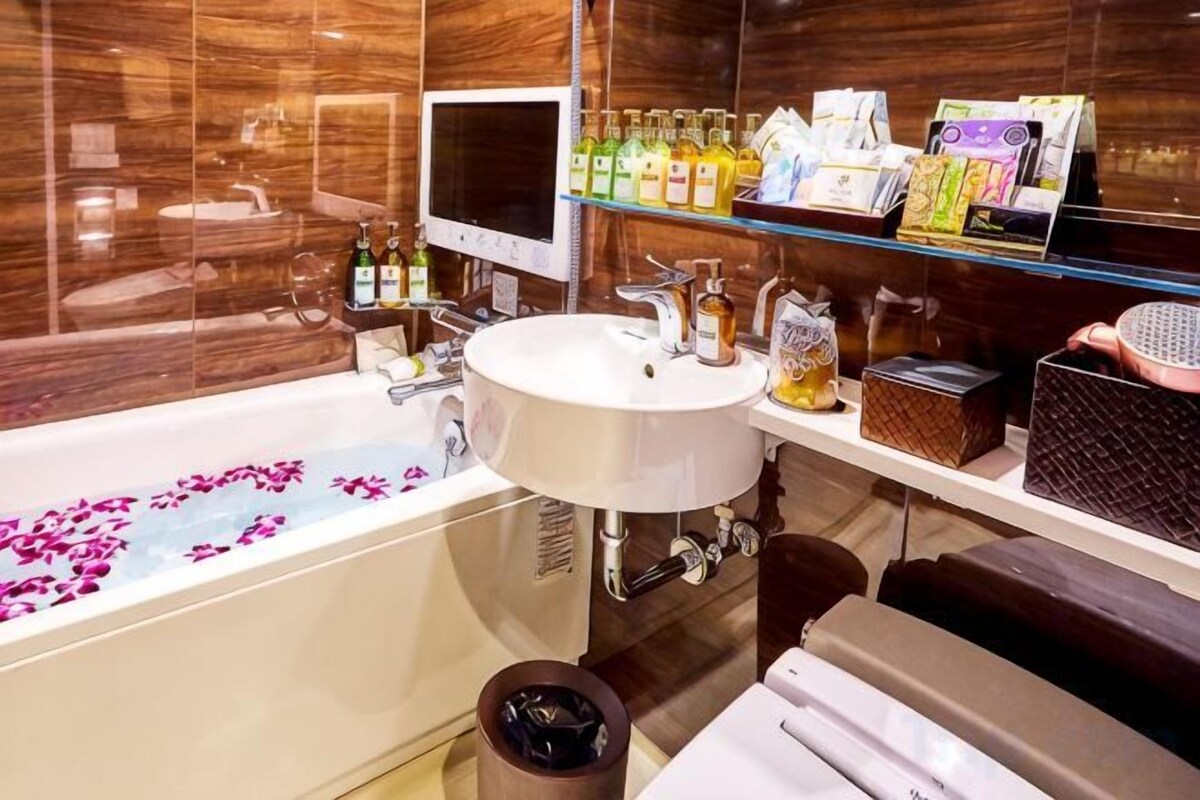 A modern bathroom with a bathtub, a sink, and a vanity.