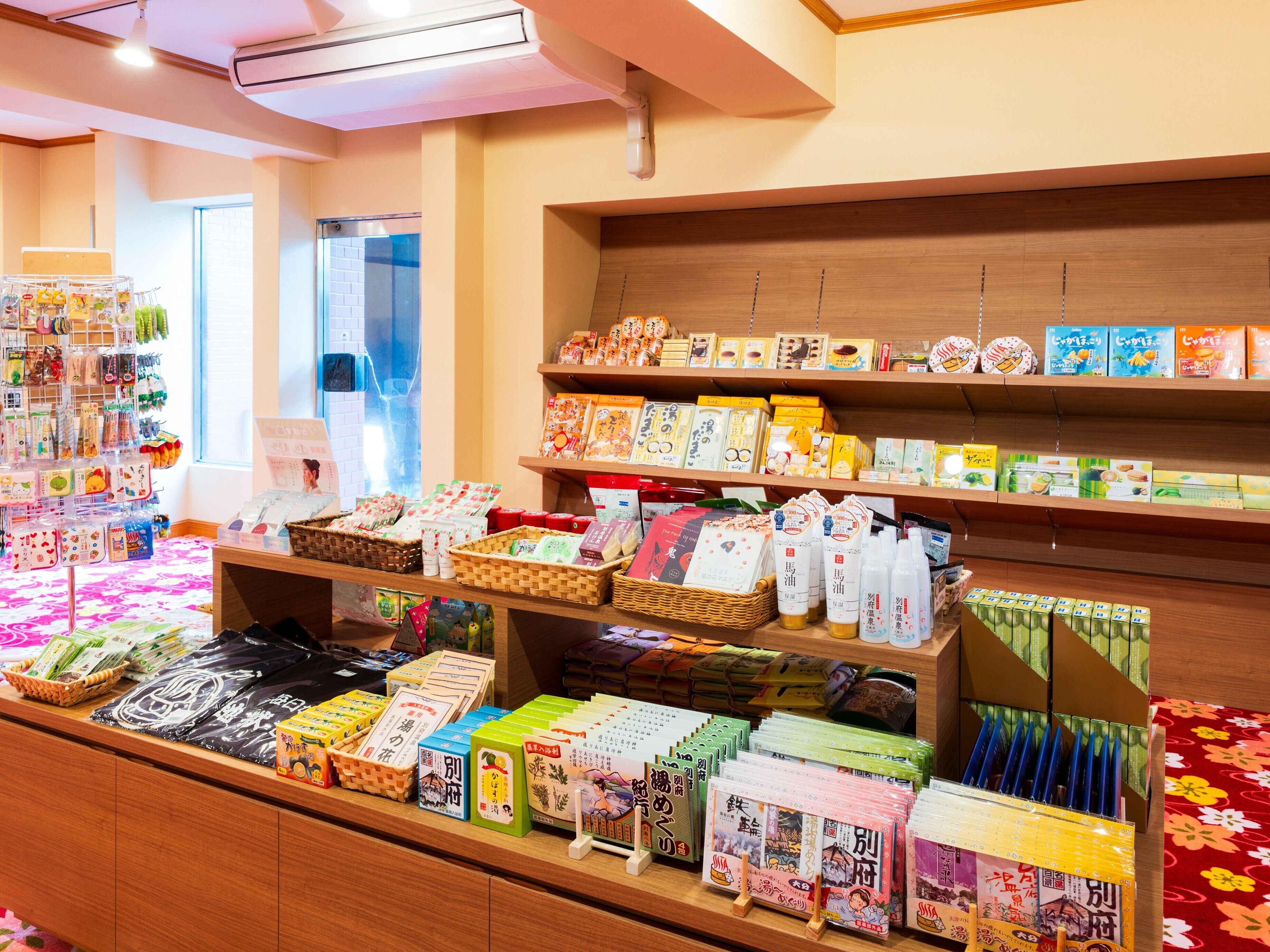 A store interior with shelves stocked with various packaged goods, baskets, and a display counter with items.