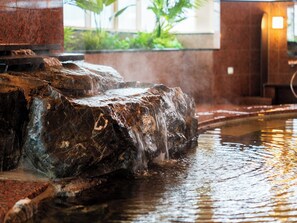 A water feature with a cascading waterfall in a stone basin. - BeppuOnsen Hotel Sansenkaku (Beppu)