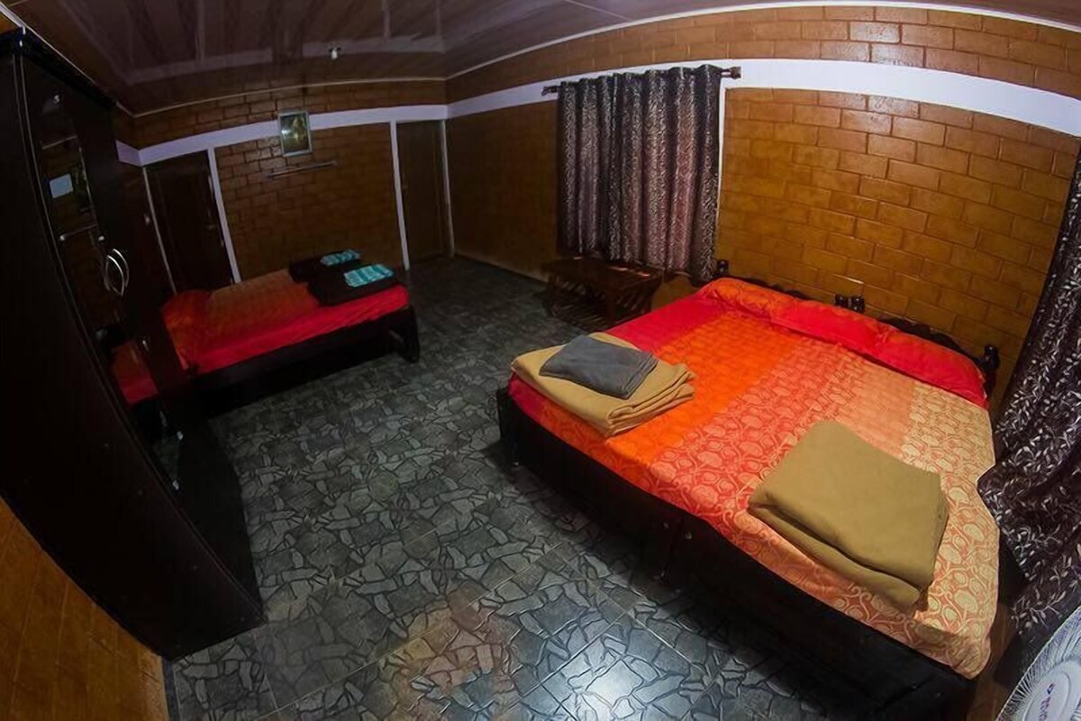 A room with a bed, a chair, and a wardrobe.