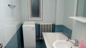 A bathroom with a white sink, a mirror, and a window. - Apartment "Life Old Town" (Bucharest)