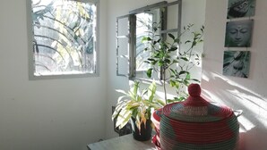 A room with a large window, a potted plant, and a decorative vase. - Quiet house near Nice (Contes)