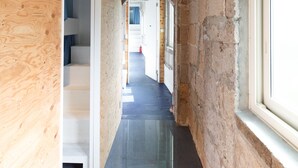 A narrow hallway with wooden walls and a tiled floor, leading to a staircase and a door at the end. - Hostel NABLA (Niijima)