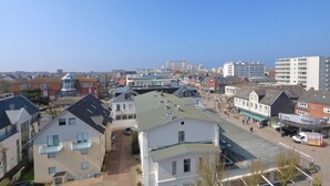 A coastal town with a mix of residential and commercial buildings, including a prominent Gabor store. - App. Rüter 57, Germany (Sylt)