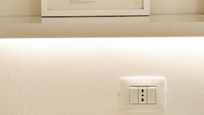 A wall with a white electrical outlet.