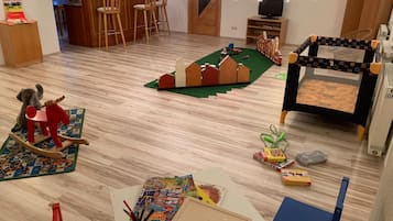 Children can play and learn in this well-organized space with a play mat, books, and creative tools.