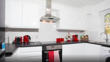 Two-Bedroom Apartment | Private kitchen | Full-sized fridge, microwave, oven, stovetop