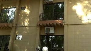 A two-story building with a beige facade, air conditioning units, and a sign indicating the address H-14. - Savoy Inn (Islamabad)