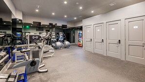 A gym with exercise equipment, a vending machine, and lockers. - WHERE GLAM MEETS COZY! THE PERFECT PLACE FOR A DOWNTOWN GETAWAY! | The Sazerac (New Orleans)