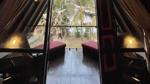A room with a view of palm trees and a beach. - Soluna Beach Resort (Marawila)