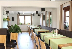 A restaurant with long tables, chairs, and a high ceiling. - Sinzingers Krone Hotel und Restaurant (Öhringen)