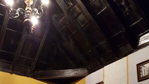 A room with a bed, a table, and a chair. There are framed pictures on the wall. - RURAL HOUSE FINCA PARAISO. for a fantastic stay north of Tenerife (San Cristóbal de La Laguna)