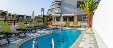 Seasonal outdoor pool, open 9:00 AM to 8:00 PM, pool umbrellas