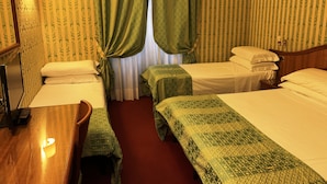 A hotel room with two single beds, a wooden desk, a mirror, and a lamp. - Hotel HI15 (Rome)