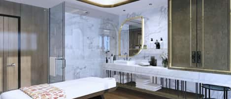 A modern hotel room with a large bed, a glass shower enclosure, a vanity with a large mirror, and a wooden floor.