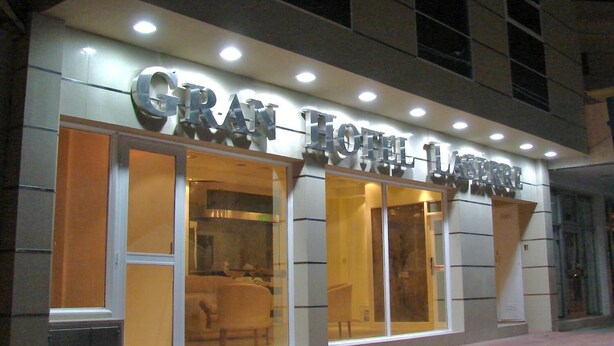 A hotel with a modern facade, large glass windows, and a prominent sign. - Gran Hotel Laserre (Río Grande)