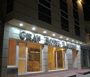 A hotel with a modern facade, large glass windows, and a prominent sign. - Gran Hotel Laserre (Río Grande)