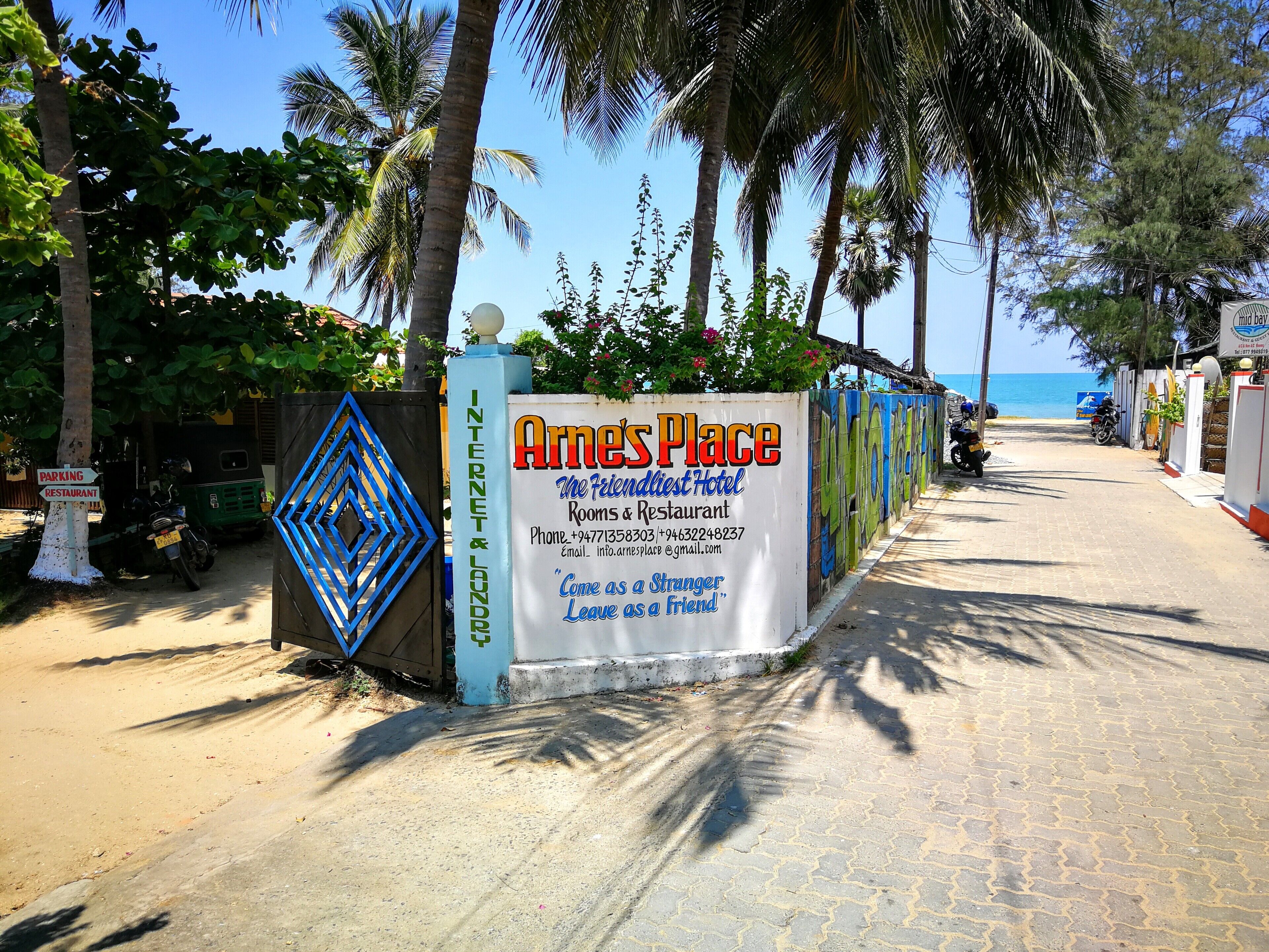 A sign for 'Arnes Place' indicating it is a hotel and restaurant with contact information.