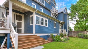 A two-story house with a front porch, a staircase leading to the entrance, and a well-maintained lawn. - Carlton Landing-Spacious home on Boulevard (Eufaula)