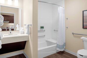 A bathroom with a sink, mirror, toilet, and shower area. - TownePlace Suites by Marriott Cincinnati Fairfield (Fairfield)