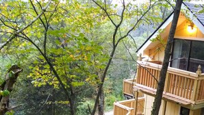 A wooden cabin with multiple balconies, surrounded by dense forest. - Remodeled Vacation Home in the Mountains - Upstairs Balconies, Patios &... (Corryton)