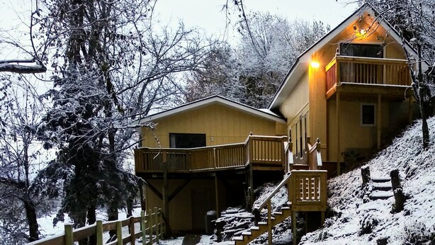 A wooden cabin with a balcony and a staircase leading to a covered area. - Remodeled Vacation Home in the Mountains - Upstairs Balconies, Patios &... (Corryton)