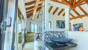 A modern kitchen with a black countertop and a mosaic backsplash. - Villa Cubismo - with a pool for 18 guests, close to restaurants and cafes by MyWaycation (Tkon)