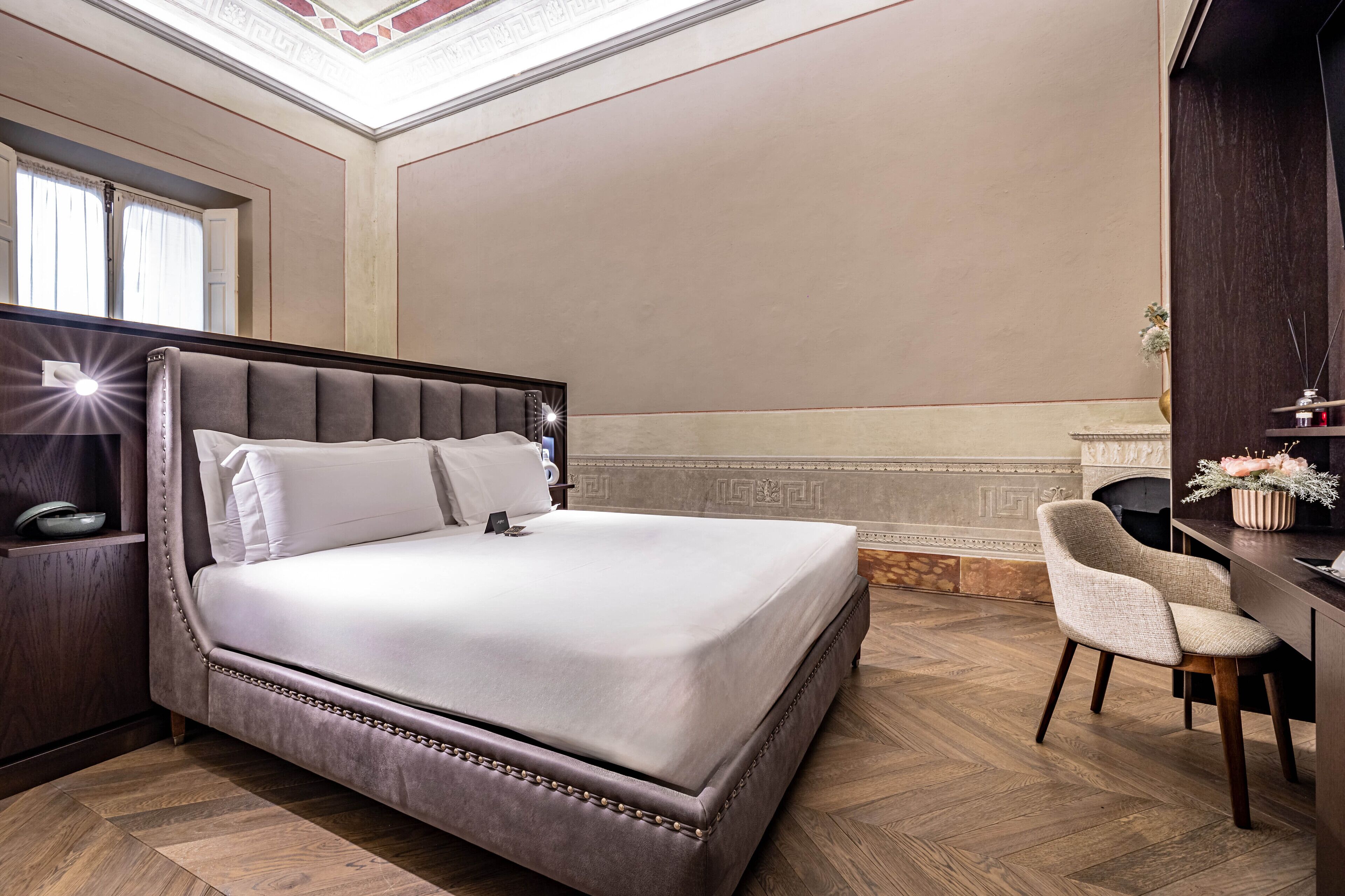 Un dormitorio con una cama grande, un escritorio y una silla.