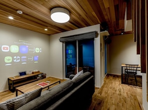 Relax in a spacious living area with a sofa, bench, and table, perfect for working or unwinding.
