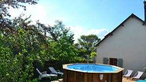 A wooden hot tub with a clear blue pool, surrounded by a deck with lounge chairs. - Maison Avec Piscine Dans un Hameau Pour 8 Personnes, Entre Lascaux et Hautefort (GRANGES D ANS)