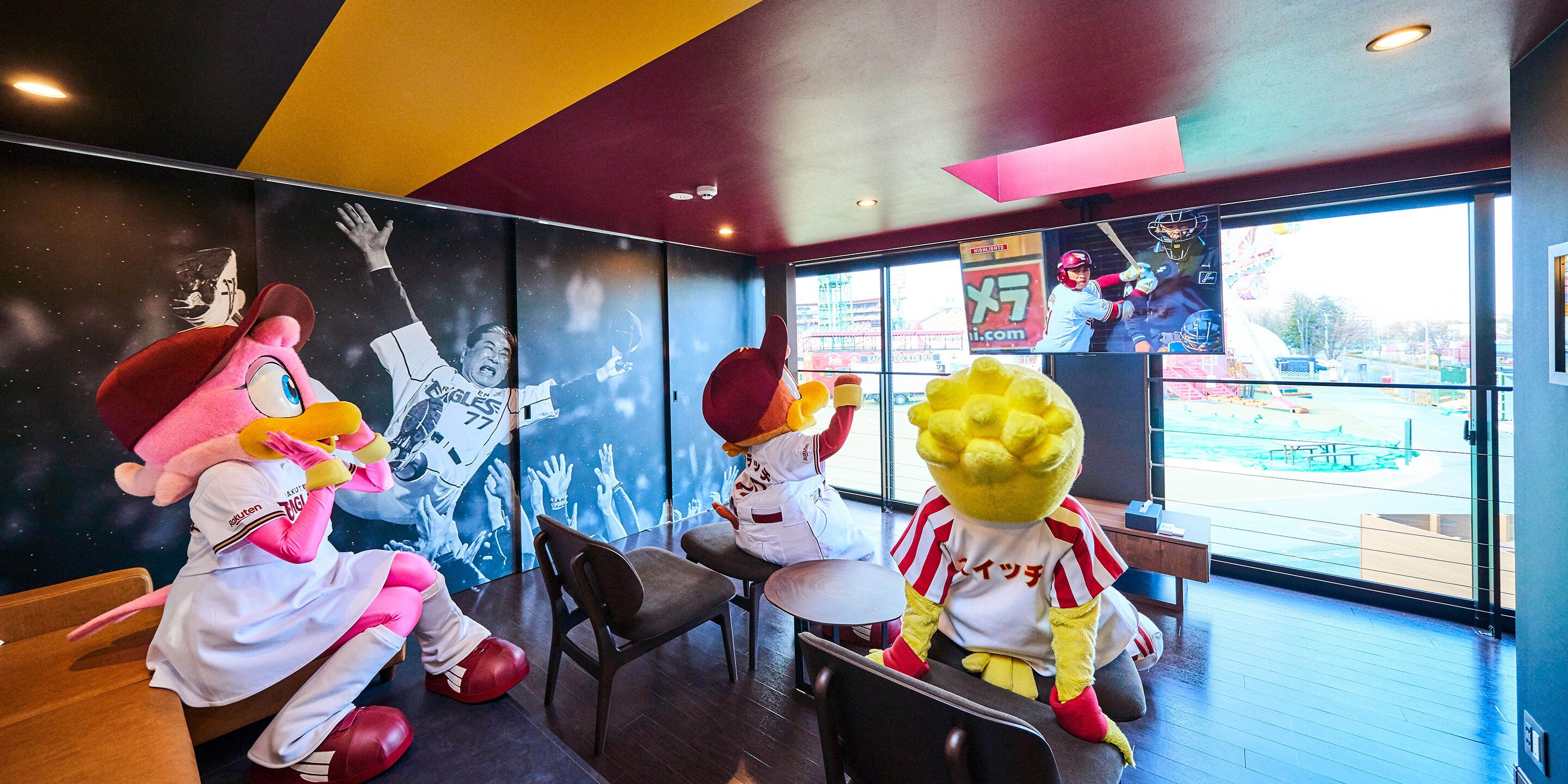 A restaurant interior with mascot characters, a large window, and a poster on the wall.