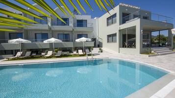 Seasonal outdoor pool, open 10:00 AM to 6:00 PM, pool umbrellas