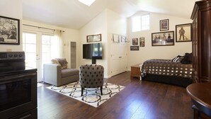 A spacious living room with a large TV, a fireplace, and a dining area. - Private Willow Glen Studio Guesthouse (San Jose)