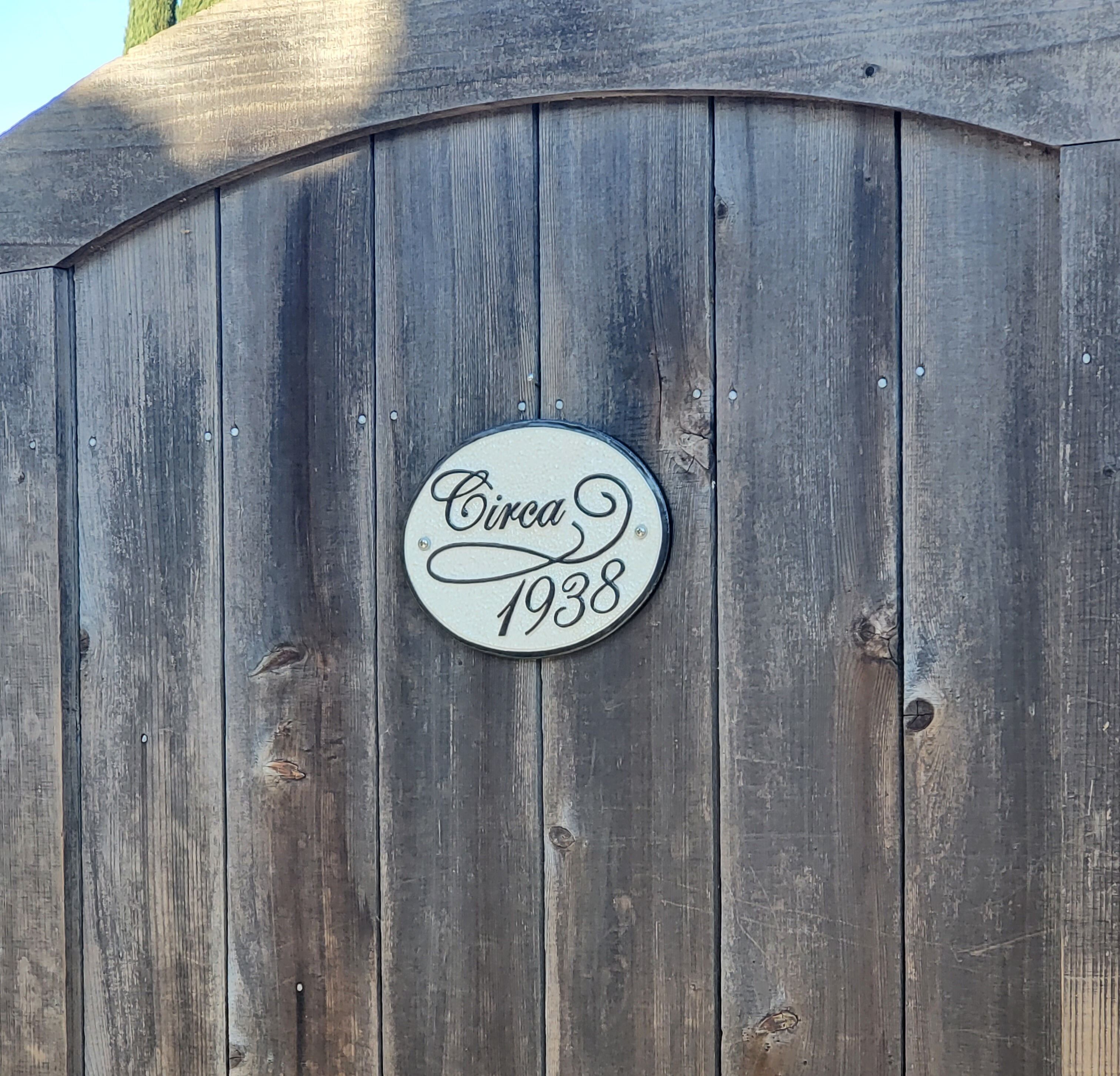 A wooden wall with a circular sign that reads "Circa 1938".