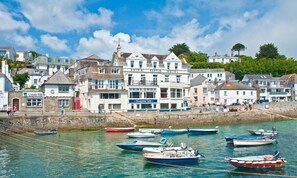 A coastal town with a prominent white building labeled 'Ship & Castle Hotel' and a 'Quayside Cafe' adjacent to it.