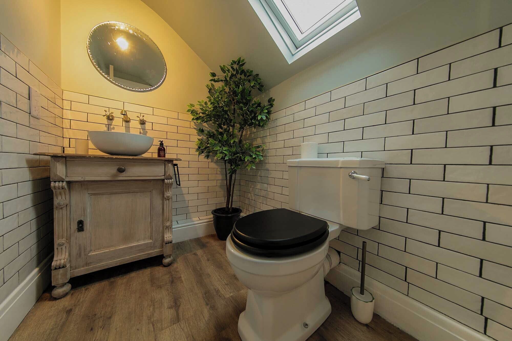 Bathtub, hair dryer, towels, toilet paper