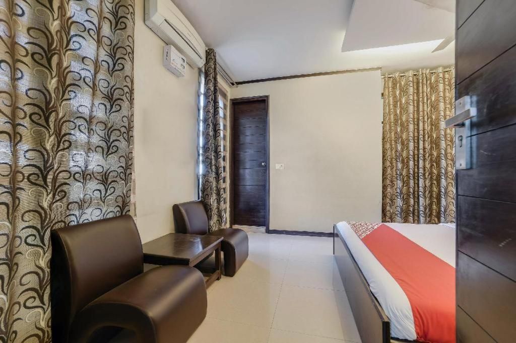 A hotel room with a bed, a desk, and a chair.